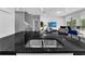 Island sink and granite countertop in an open-concept kitchen with stainless steel fixtures and seating at 518 Marcello Blvd, Kissimmee, FL 34746