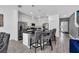 Kitchen with island, barstool seating, stainless appliances, and modern lighting at 518 Marcello Blvd, Kissimmee, FL 34746