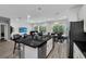 Open-concept kitchen with large island, barstool seating, and a stainless steel dishwasher at 518 Marcello Blvd, Kissimmee, FL 34746