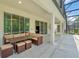 Covered patio with outdoor dining and living area, perfect for entertaining at 518 Marcello Blvd, Kissimmee, FL 34746