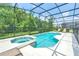 Screened-in pool with hot tub and well-maintained landscaping at 518 Marcello Blvd, Kissimmee, FL 34746