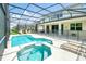 Sparkling screened-in pool and jacuzzi with lounge area and home exterior in background at 518 Marcello Blvd, Kissimmee, FL 34746