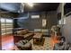 Finished basement with dark walls, a foosball table, couches, and a unique rug for a cozy feel at 531 Lasso Dr, Kissimmee, FL 34747