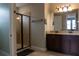 Bright bathroom features a granite vanity, walk-in shower, and decorative mirror at 531 Lasso Dr, Kissimmee, FL 34747