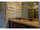 Well-lit bathroom featuring double sinks, granite countertops, and framed artwork at 531 Lasso Dr, Kissimmee, FL 34747