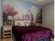 The bedroom has a decorative mural, side table, and comfy-looking bed for relaxing at 531 Lasso Dr, Kissimmee, FL 34747