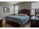 Well-lit bedroom features two large windows, a wood bed frame, and comfortable decor at 531 Lasso Dr, Kissimmee, FL 34747