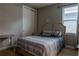 Neutral bedroom featuring a queen bed with upholstered headboard, closet, and window with blinds at 531 Lasso Dr, Kissimmee, FL 34747