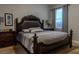 Comfortable bedroom features a dark wood bed frame, gray walls, and soft carpeting at 531 Lasso Dr, Kissimmee, FL 34747