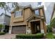 Inviting two-story home featuring a brick driveway, two-car garage, and a meticulously maintained lawn at 531 Lasso Dr, Kissimmee, FL 34747