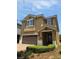 Charming two-story home with a tile roof, an attached two-car garage, and a manicured front yard at 531 Lasso Dr, Kissimmee, FL 34747