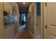 Long hallway with neutral paint, carpet, and pictures, leading to the bedrooms at 531 Lasso Dr, Kissimmee, FL 34747