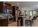 Spacious kitchen with stainless steel appliances, granite countertops, dark wood cabinets and breakfast bar at 531 Lasso Dr, Kissimmee, FL 34747
