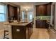 Well-equipped kitchen with granite countertops, stainless steel appliances, and dark wood cabinets at 531 Lasso Dr, Kissimmee, FL 34747