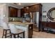 Stylish kitchen featuring stainless steel appliances, granite countertops, and dark wood cabinetry at 531 Lasso Dr, Kissimmee, FL 34747