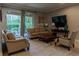 Cozy living room with sliding glass doors to the pool area, featuring comfortable seating at 531 Lasso Dr, Kissimmee, FL 34747