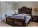 The main bedroom features an ornate, dark wood sleigh bed and two side tables with lamps at 531 Lasso Dr, Kissimmee, FL 34747
