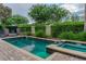 Inviting community pool and spa area with privacy landscaping, lounge chairs, and brick paver deck at 531 Lasso Dr, Kissimmee, FL 34747