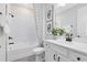 This bathroom has tile flooring, a shower-tub combo with a patterned shower curtain, and a white vanity at 5512 Settlingstone Ln, St Cloud, FL 34771