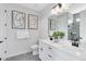 Modern bathroom with double vanity, stylish mirrors, and decorative artwork at 5512 Settlingstone Ln, St Cloud, FL 34771