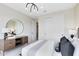 This bedroom features neutral walls, carpet, a large mirror and dresser, and a bright light fixture above the bed at 5512 Settlingstone Ln, St Cloud, FL 34771