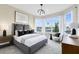 Bedroom with large windows, neutral walls, and stylish furniture at 5512 Settlingstone Ln, St Cloud, FL 34771