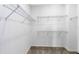 Empty walk-in closet with metal shelving in a new home at 5512 Settlingstone Ln, St Cloud, FL 34771