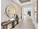 Hallway with neutral walls, tiled floors, a tray ceiling and decor at 5512 Settlingstone Ln, St Cloud, FL 34771
