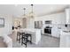 Bright kitchen with white cabinets, stainless steel appliances, and a central island with bar seating at 5512 Settlingstone Ln, St Cloud, FL 34771
