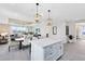 Stylish kitchen featuring a large island, quartz countertops, and stainless steel appliances at 5512 Settlingstone Ln, St Cloud, FL 34771