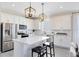 Modern kitchen with stainless steel appliances, white cabinets, and bar seating at the island at 5512 Settlingstone Ln, St Cloud, FL 34771