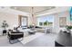 Spacious living room with modern decor, large windows, and stylish accent wall at 5512 Settlingstone Ln, St Cloud, FL 34771