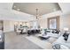 Open-concept living room and kitchen featuring modern finishes and plenty of natural light at 5512 Settlingstone Ln, St Cloud, FL 34771