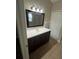 Modern bathroom featuring a vanity with countertop and a large mirror at 581 Farmingham Ct, Oviedo, FL 32765