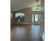 Foyer featuring a vaulted ceiling, transom window, and tile floor creating a welcoming entrance at 581 Farmingham Ct, Oviedo, FL 32765