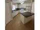 Well-appointed kitchen featuring white cabinets, granite countertops and a center island at 581 Farmingham Ct, Oviedo, FL 32765