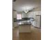 Bright kitchen with white cabinets, granite counters, tiled floor, and a convenient center island at 581 Farmingham Ct, Oviedo, FL 32765