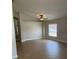 Living room with neutral walls, tile floor, ceiling fan, and natural light from the window at 581 Farmingham Ct, Oviedo, FL 32765