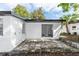 Backyard patio with sliding glass doors, white exterior, and concrete pavers, ideal for outdoor lounging at 657 Lear Ter, Deltona, FL 32725
