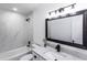 Updated bathroom with granite counters, modern fixtures and a shower-over-tub with marbled tile surround at 657 Lear Ter, Deltona, FL 32725