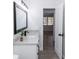 Bright bathroom boasts stylish vanity with black fixtures, granite counter, and a doorway leading to a bedroom at 657 Lear Ter, Deltona, FL 32725
