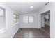 Bright dining area with large windows, tile flooring, and neutral paint, offering versatile space at 657 Lear Ter, Deltona, FL 32725