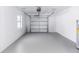 Clean and spacious garage with a roll-up door and a utility window for natural lighting at 657 Lear Ter, Deltona, FL 32725