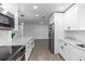 Open-concept kitchen with a large island, stainless steel appliances, and white cabinetry at 657 Lear Ter, Deltona, FL 32725