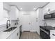 Bright kitchen featuring stainless steel appliances, granite countertops, and modern fixtures at 657 Lear Ter, Deltona, FL 32725