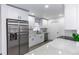 Modern kitchen with stainless steel appliances, granite countertops, and stylish white cabinetry at 657 Lear Ter, Deltona, FL 32725