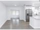 Spacious living area with tile flooring seamlessly connecting to the modern kitchen at 657 Lear Ter, Deltona, FL 32725