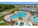 Aerial view of neighborhood amenities including clubhouse, pool, playground, splashpad, and green space at 6611 Leo Ln, St Cloud, FL 34773