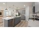 Kitchen with an island and stainless steel appliances, open to the living room at 7262 Summer Ivy Aly, Orlando, FL 32829
