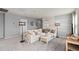 Spacious loft living area with a comfortable couch and a modern coffee table in neutral tones at 7262 Summer Ivy Aly, Orlando, FL 32829